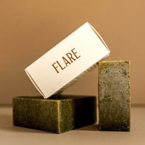 Natural Flare soap bar with earthy tones and textured surface.