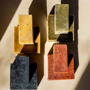 Natural soap bars displayed on a light surface, casting shadows, perfect for event decor or gift ide.